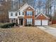 Charming two-story home featuring brick accents, a two-car garage, and a well-maintained front yard at 184 Chamberlyn Ln, Hiram, GA 30141