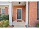 Inviting front entrance with a brick surround, classic door, and decorative columns at 184 Chamberlyn Ln, Hiram, GA 30141
