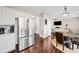 Bright kitchen with stainless steel refrigerator, white cabinets, and an adjacent dining area and living room at 184 Chamberlyn Ln, Hiram, GA 30141