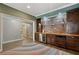 Stylish bar area featuring custom cabinetry, shelving, and a wine refrigerator at 2241 Harry Brooks Nw Dr, Atlanta, GA 30318