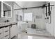 Spa-like bath boasts white cabinets, double vanities, glass shower, freestanding tub, and custom finishes at 2241 Harry Brooks Nw Dr, Atlanta, GA 30318