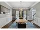 Formal dining room showcases wainscoting, modern lighting, and large picture window at 2241 Harry Brooks Nw Dr, Atlanta, GA 30318
