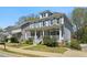 Two-story home featuring a charming front porch with white railing and beautifully maintained landscaping at 2241 Harry Brooks Nw Dr, Atlanta, GA 30318