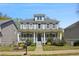 Charming two-story home with a welcoming front porch and manicured landscaping at 2241 Harry Brooks Nw Dr, Atlanta, GA 30318