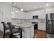 Bright kitchen features white cabinetry, granite countertops, stainless steel appliances, and bar seating at 2241 Harry Brooks Nw Dr, Atlanta, GA 30318