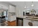 Eat-in kitchen boasts stainless appliances, granite counters, breakfast bar, and tile backsplash at 2241 Harry Brooks Nw Dr, Atlanta, GA 30318
