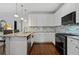 Bright kitchen features white cabinetry, granite countertops, tile backsplash, and stainless appliances at 2241 Harry Brooks Nw Dr, Atlanta, GA 30318