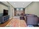 Inviting living room with a wet bar, large sectional sofa, and media center at 2241 Harry Brooks Nw Dr, Atlanta, GA 30318