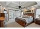 Spacious main bedroom with tray ceilings, ceiling fan, and ensuite bath with sliding barn door at 2241 Harry Brooks Nw Dr, Atlanta, GA 30318