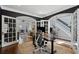 Home office featuring French doors, hardwood floors, and stylish black accent wall at 2241 Harry Brooks Nw Dr, Atlanta, GA 30318