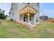 Exterior view of the home featuring a wooden deck, a walkout basement entrance and a green lawn at 255 Arnewood Cir, Mcdonough, GA 30253