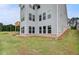 Backyard view showcasing the home's gray siding, multiple windows, and wooden deck at 255 Arnewood Cir, Mcdonough, GA 30253