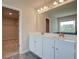 Bathroom featuring double vanity, ample mirror, tile flooring, and access to walk-in closet at 255 Arnewood Cir, Mcdonough, GA 30253