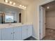 Elegant bathroom featuring a double vanity, and an open door that reveals a large walk-in closet at 255 Arnewood Cir, Mcdonough, GA 30253