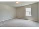 Neutral bedroom featuring cozy carpeting and a window for natural light at 255 Arnewood Cir, Mcdonough, GA 30253