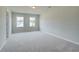 Bright bedroom featuring plush carpeting and double windows providing natural light at 255 Arnewood Cir, Mcdonough, GA 30253