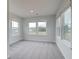 Sunny bedroom with two large windows offering an outside view and plush gray carpet at 255 Arnewood Cir, Mcdonough, GA 30253