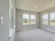 Well-lit bedroom featuring neutral walls, plush carpeting and multiple windows at 255 Arnewood Cir, Mcdonough, GA 30253