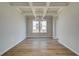 Elegant dining room featuring hardwood floors, coffered ceiling and a modern chandelier at 255 Arnewood Cir, Mcdonough, GA 30253
