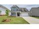 Beautiful two-story home featuring manicured lawn, brick accents, and two-car garage at 255 Arnewood Cir, Mcdonough, GA 30253