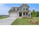 Beautiful two-story home featuring a covered porch, an attached garage, and manicured front yard at 255 Arnewood Cir, Mcdonough, GA 30253