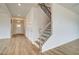 Hallway with hardwood floors and view of staircase at 255 Arnewood Cir, Mcdonough, GA 30253