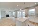 Modern kitchen features a center island, stainless steel appliances, and an open-concept layout perfect for gatherings at 255 Arnewood Cir, Mcdonough, GA 30253