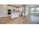 Beautiful kitchen featuring white cabinets, stainless steel appliances, a center island, and luxury vinyl plank flooring at 255 Arnewood Cir, Mcdonough, GA 30253