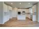 Bright kitchen features white cabinets, stainless steel appliances, an island, and luxury vinyl plank flooring at 255 Arnewood Cir, Mcdonough, GA 30253