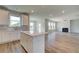 Modern kitchen with white cabinetry, stainless steel appliances, and a view into the living area at 255 Arnewood Cir, Mcdonough, GA 30253