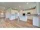 Kitchen boasts white cabinets, stainless steel appliances, a center island, and luxury vinyl plank flooring at 255 Arnewood Cir, Mcdonough, GA 30253