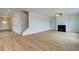 Bright and spacious living room boasts hardwood floors, a cozy fireplace, and stairs leading up at 255 Arnewood Cir, Mcdonough, GA 30253