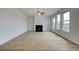 Open living room featuring a fireplace, hardwood floors, ample natural light and ceiling fan at 255 Arnewood Cir, Mcdonough, GA 30253