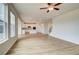 Spacious living room with wood floors, white walls, and large windows for plenty of natural light at 255 Arnewood Cir, Mcdonough, GA 30253