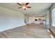 Open-concept layout with luxury vinyl plank flooring connecting the living room to a modern, all-white kitchen at 255 Arnewood Cir, Mcdonough, GA 30253