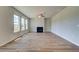 Bright living room featuring luxury vinyl plank flooring, a cozy fireplace, and ample natural light from large windows at 255 Arnewood Cir, Mcdonough, GA 30253