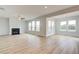 Bright living room featuring a cozy fireplace, ample natural light, and wood-look floors throughout at 255 Arnewood Cir, Mcdonough, GA 30253