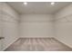 Spacious walk-in closet with carpet, built-in shelving, and ample storage space for clothes and accessories at 255 Arnewood Cir, Mcdonough, GA 30253
