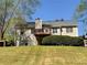 Large grassy backyard features a deck, a storage shed, and well-maintained landscaping at 262 Bomar Ln, Douglasville, GA 30134