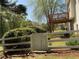 Well-maintained backyard features a white gate, mature trees, and a partial view of a wood deck at 262 Bomar Ln, Douglasville, GA 30134
