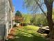 A spacious backyard with a wooden deck, shed, and bordered by mature trees for privacy at 262 Bomar Ln, Douglasville, GA 30134