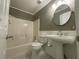 Charming bathroom with a pedestal sink, tiled shower, and classic fixtures at 262 Bomar Ln, Douglasville, GA 30134