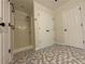 Modern bathroom with a walk-in shower, white cabinets, and patterned tile flooring at 262 Bomar Ln, Douglasville, GA 30134