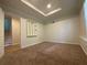 Neutral bedroom with tray ceilings, carpet and a unique, decorative wall shelf at 262 Bomar Ln, Douglasville, GA 30134