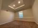 A bedroom with wall-to-wall carpeting, a modern ceiling and a window at 262 Bomar Ln, Douglasville, GA 30134