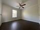 A bedroom featuring a ceiling fan, window and dark-wood flooring at 262 Bomar Ln, Douglasville, GA 30134