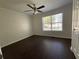 Inviting bedroom with modern ceiling fan, dark wood floors, and a window for natural light at 262 Bomar Ln, Douglasville, GA 30134