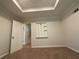 Neutral bedroom with tray ceilings, carpet and a unique, decorative wall shelf at 262 Bomar Ln, Douglasville, GA 30134