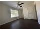 A spacious bedroom featuring hardwood floors, a ceiling fan, and a window for natural light at 262 Bomar Ln, Douglasville, GA 30134