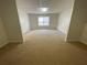 A bonus room with wall-to-wall carpeting, and a window in the background at 262 Bomar Ln, Douglasville, GA 30134